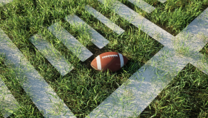 This photo shows a spotlight on the football field, by Alexander Mils, Unsplash.

